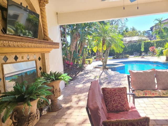 view of swimming pool featuring a patio area and ceiling fan