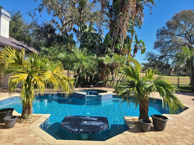 view of pool featuring an in ground hot tub