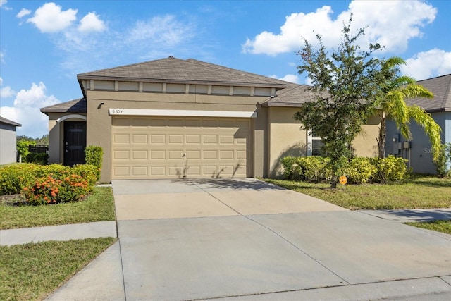 view of front of home featuring a garage and a front lawn