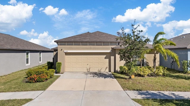 view of front of property with a garage and a front lawn