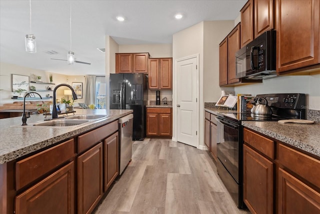 kitchen featuring ceiling fan, sink, black appliances, pendant lighting, and light hardwood / wood-style flooring