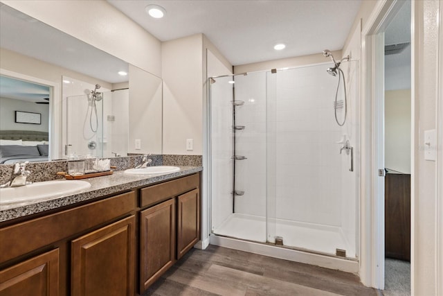 bathroom with wood-type flooring, vanity, and walk in shower