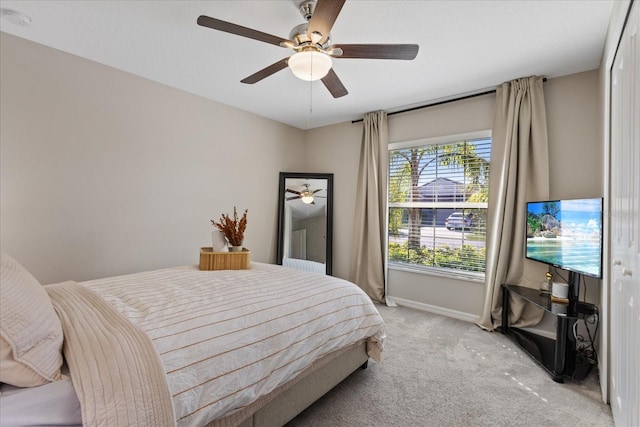 bedroom featuring ceiling fan and light carpet