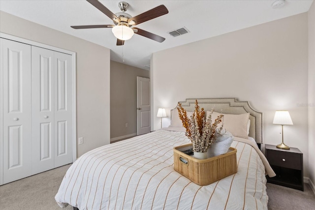 carpeted bedroom featuring a closet and ceiling fan