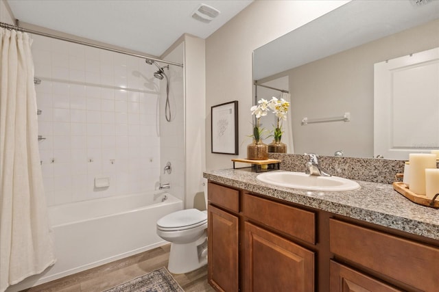 full bathroom featuring vanity, wood-type flooring, shower / tub combo, and toilet