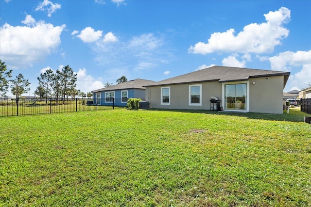 rear view of house with a yard