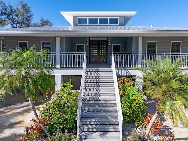 view of front facade featuring a porch and french doors