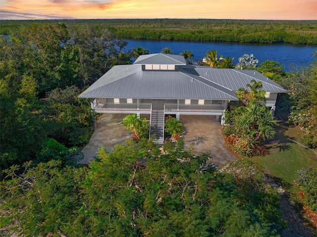 aerial view at dusk with a water view