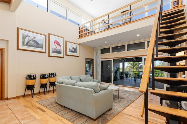 living room featuring a high ceiling and wood-type flooring