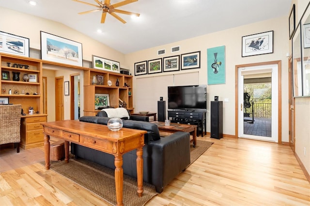 living room featuring ceiling fan, light hardwood / wood-style floors, and vaulted ceiling