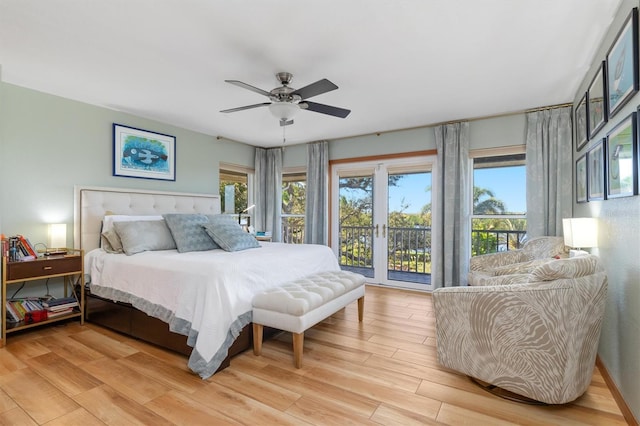 bedroom with access to outside, light hardwood / wood-style flooring, multiple windows, and ceiling fan