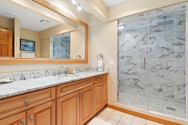 bathroom featuring tile patterned floors, vanity, and walk in shower