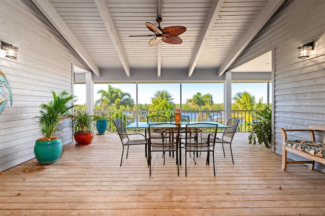 sunroom / solarium featuring vaulted ceiling with beams, plenty of natural light, and ceiling fan