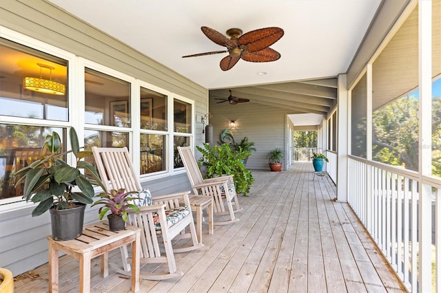 wooden terrace featuring ceiling fan and covered porch