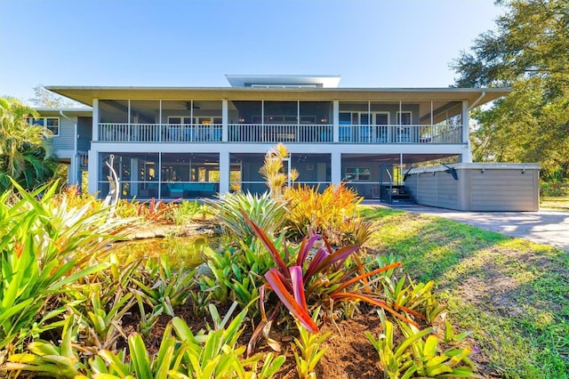 view of front of house with a hot tub and a sunroom