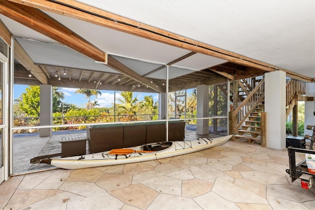 unfurnished sunroom featuring track lighting