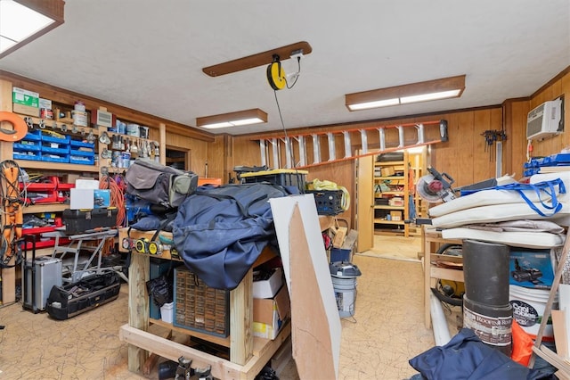 garage featuring a wall mounted air conditioner and wooden walls