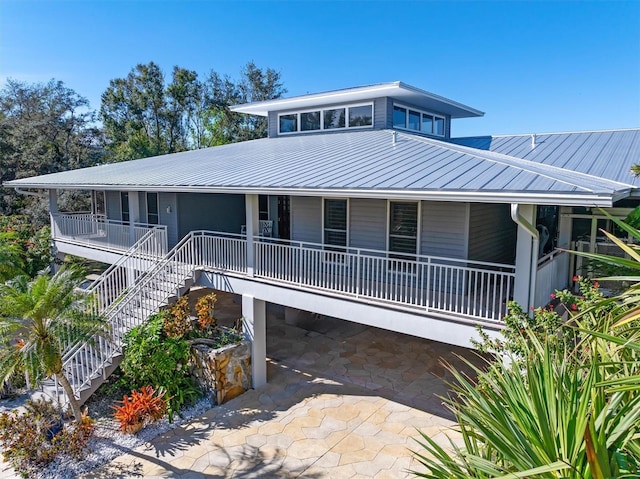 view of front of house featuring covered porch and a carport