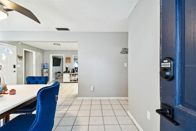 tiled dining area featuring ceiling fan