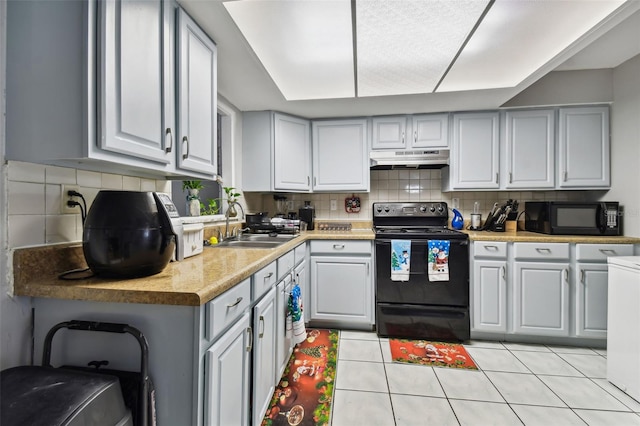 kitchen featuring light tile patterned floors, sink, gray cabinets, and black appliances