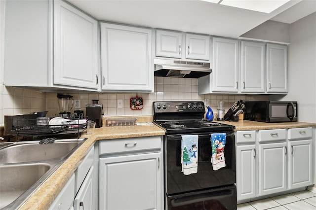 kitchen featuring light tile patterned flooring, white cabinets, and black appliances