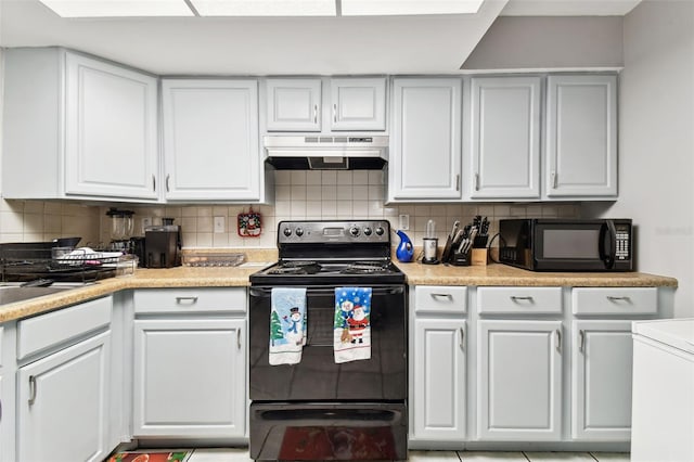 kitchen featuring black appliances, white cabinetry, and tasteful backsplash