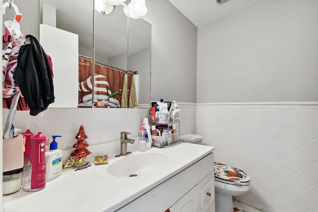 bathroom with vanity, toilet, tile walls, and curtained shower