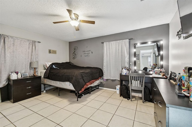 tiled bedroom featuring ceiling fan and a textured ceiling