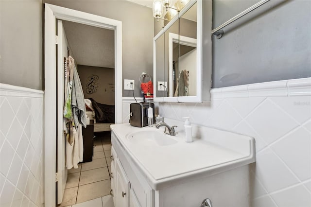 bathroom with tile patterned floors, vanity, and tile walls