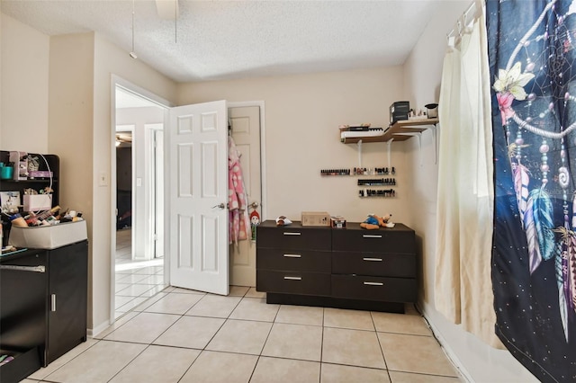 interior space with tile patterned flooring and a textured ceiling