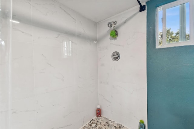 bathroom with a tile shower