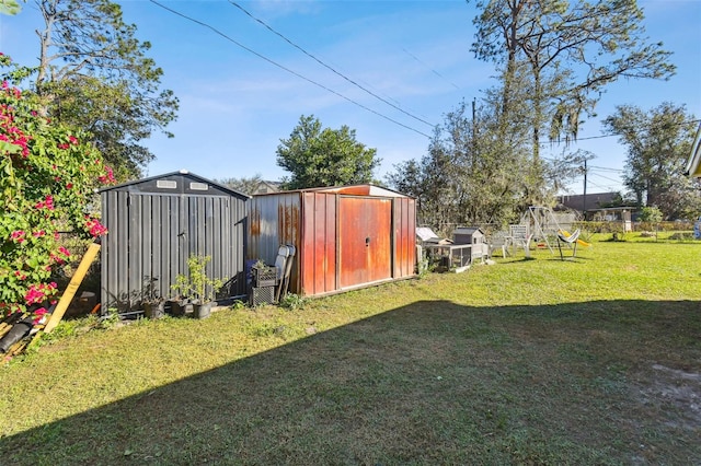 view of yard with a storage shed and an outbuilding