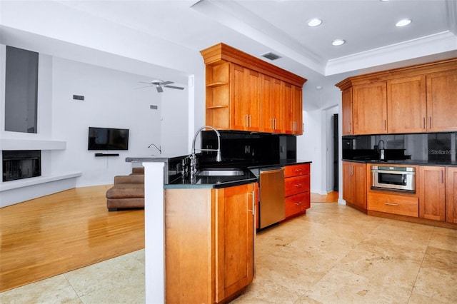 kitchen with sink, tasteful backsplash, crown molding, light hardwood / wood-style floors, and appliances with stainless steel finishes