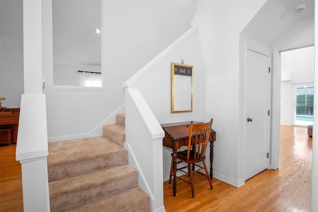 stairway with hardwood / wood-style flooring