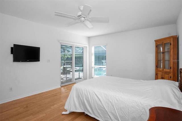 bedroom featuring access to exterior, light wood-type flooring, and ceiling fan