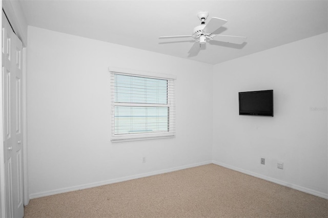 unfurnished bedroom with ceiling fan, a closet, and carpet