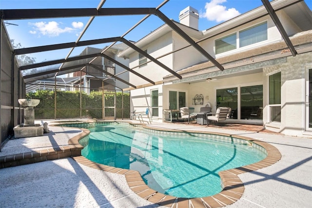 view of pool with ceiling fan, a lanai, and a patio