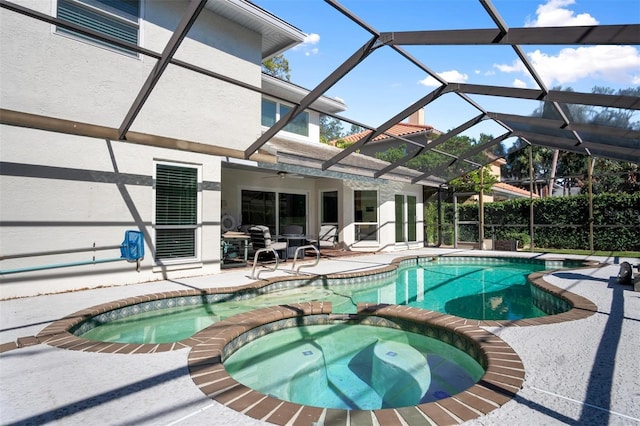 view of swimming pool with a lanai, an in ground hot tub, ceiling fan, and a patio