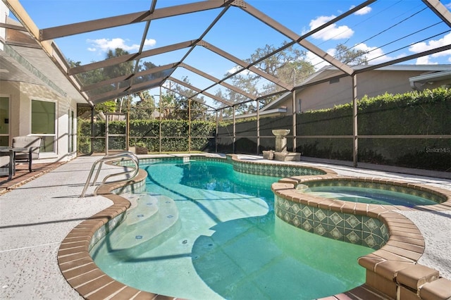 view of swimming pool with an in ground hot tub, a patio, and a lanai