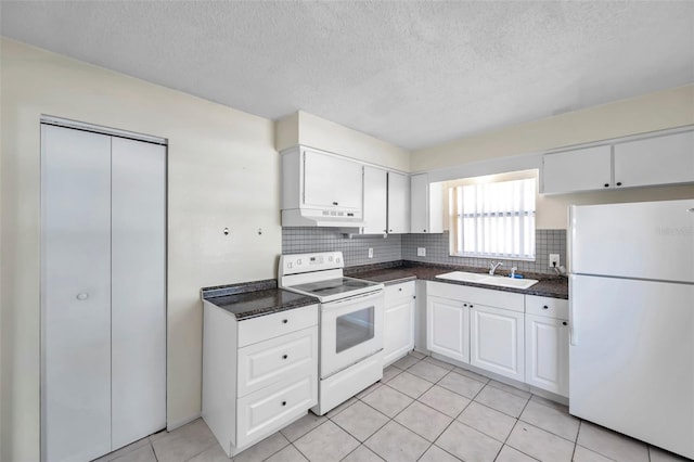 kitchen featuring sink, light tile patterned floors, white appliances, decorative backsplash, and white cabinets