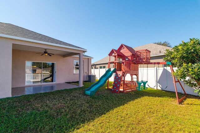 view of playground with a yard and central AC unit