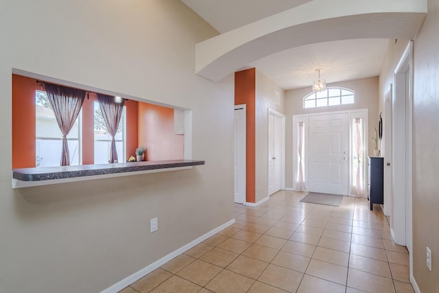 tiled foyer featuring plenty of natural light