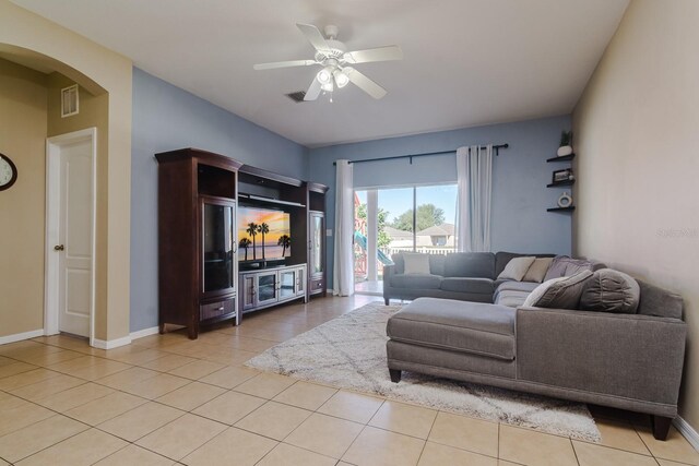 tiled living room featuring ceiling fan