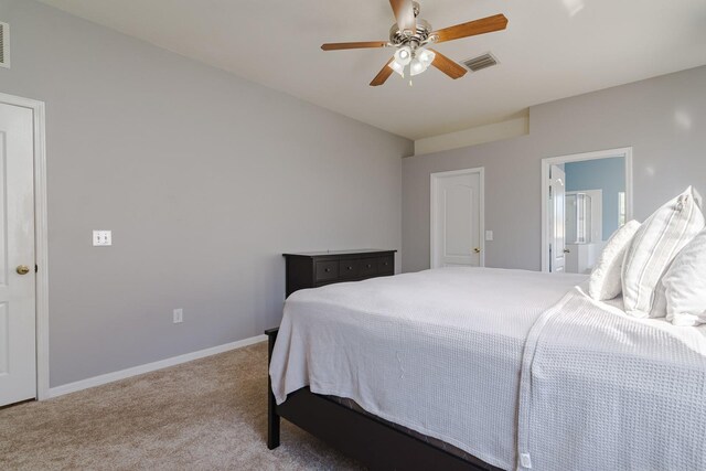 carpeted bedroom featuring ensuite bathroom and ceiling fan