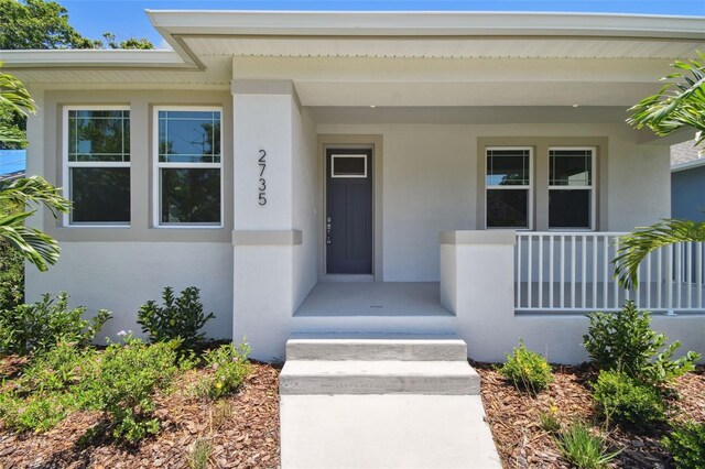 2735 36th Ave N, Saint Petersburg, FL 33713 - doorway to property featuring stucco siding and covered porch
