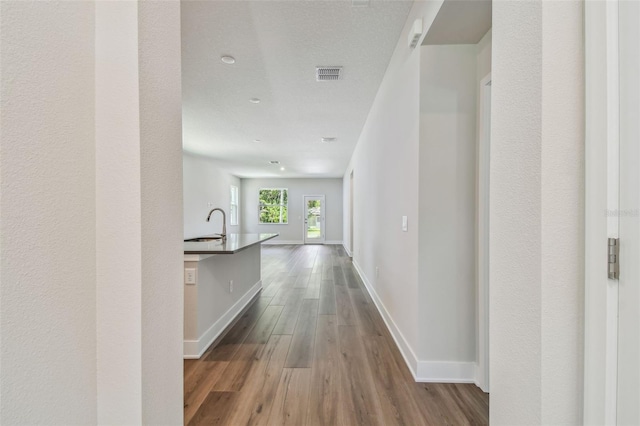 2735 36th Ave N, Saint Petersburg, FL 33713 - hall featuring dark wood-style flooring, baseboards, and a sink