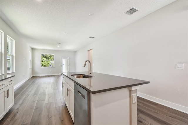 2735 36th Ave N, Saint Petersburg, FL 33713 - kitchen with a sink, stainless steel dishwasher, dark countertops, wood finished floors, and a textured ceiling