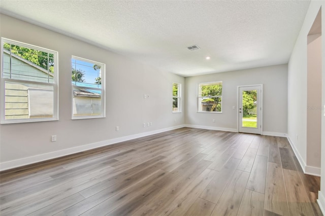 2735 36th Ave N, Saint Petersburg, FL 33713 - unfurnished room featuring wood finished floors, a textured ceiling, and baseboards