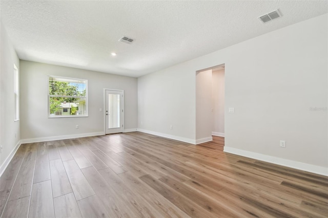 2735 36th Ave N, Saint Petersburg, FL 33713 - spare room with wood finished floors, baseboards, and a textured ceiling