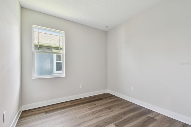 2735 36th Ave N, Saint Petersburg, FL 33713 - unfurnished room featuring wood finished floors, baseboards, and a textured ceiling